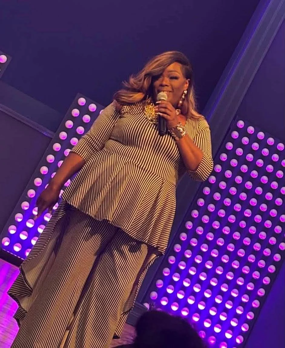 Amelia bringing her personality to the stage under purple lights